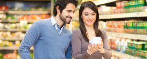 couple looking at natural dairy products labels