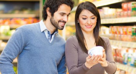couple looking at natural dairy products labels