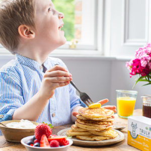 an image of a child enjoying pancakes