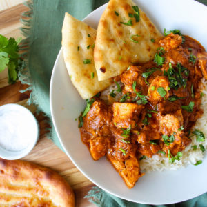butter chicken with naan bread and rice
