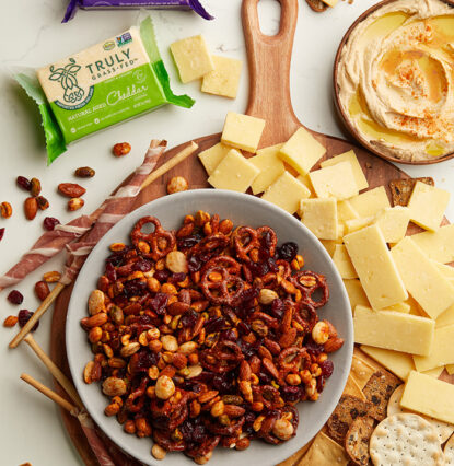 bowl of peanuts and cheese on a board